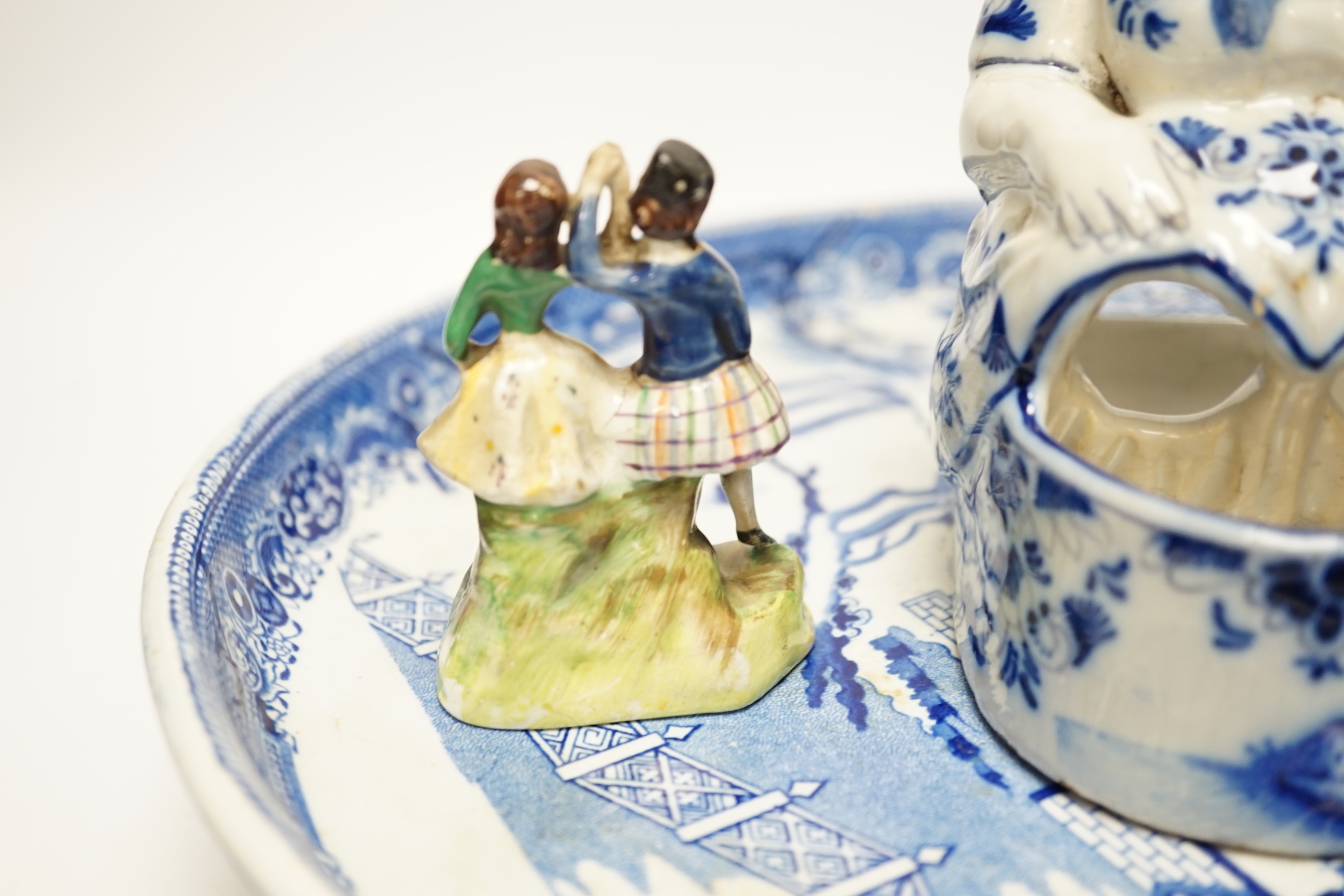 A group of mixed ceramics including a Moser crackle glass fish vase, Delft seated lady figurine, willow pattern comport, figural soap dish, maiolica match strike etc.